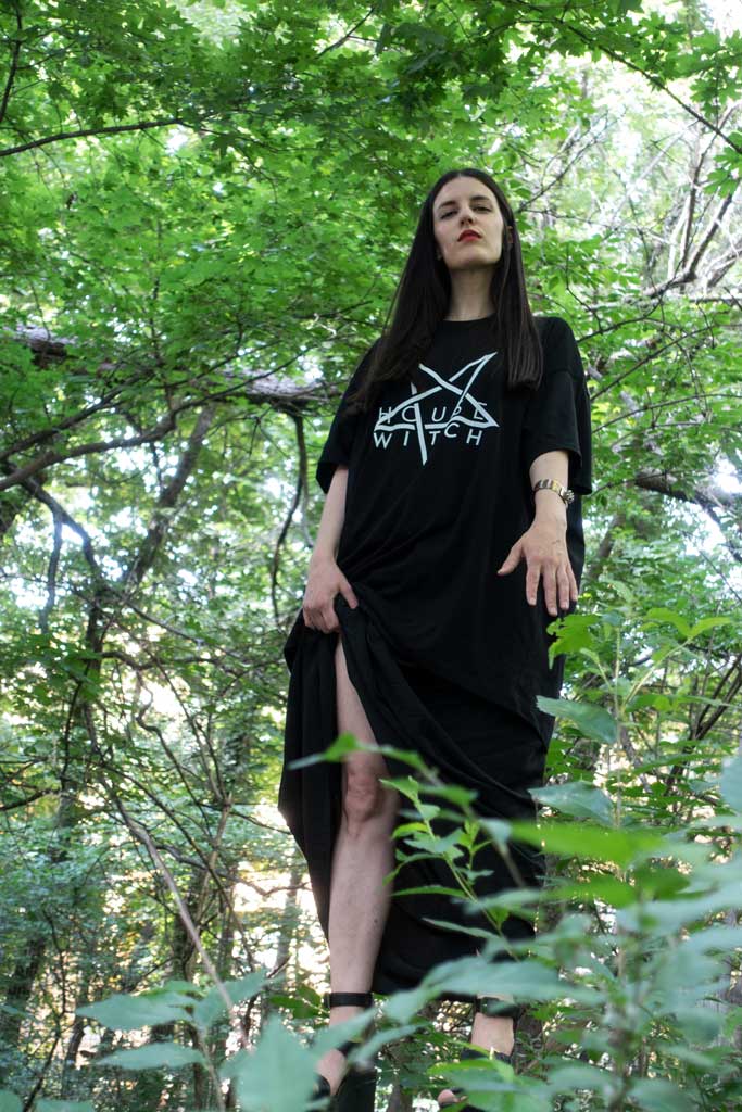 Woman standing in a forrest wearing Witch House, a black 4XL T-Shirt by House of the House.